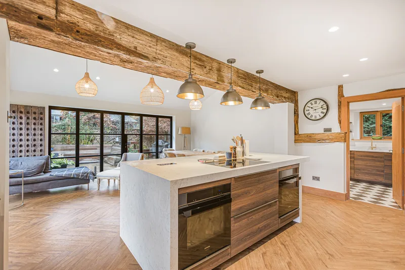 Wide view of the kitchen island and timber cabinetry in the Barn Conversion
