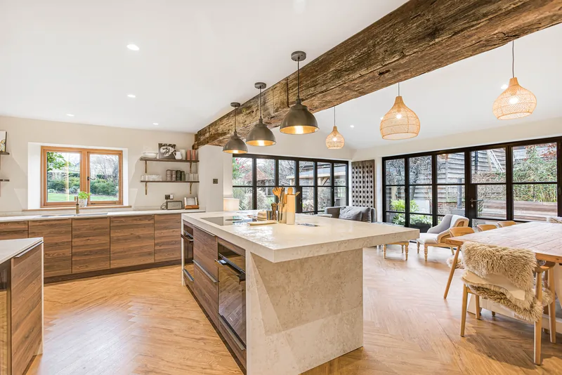 Kitchen island with exposed timber and glazed doors in the Barn Conversion