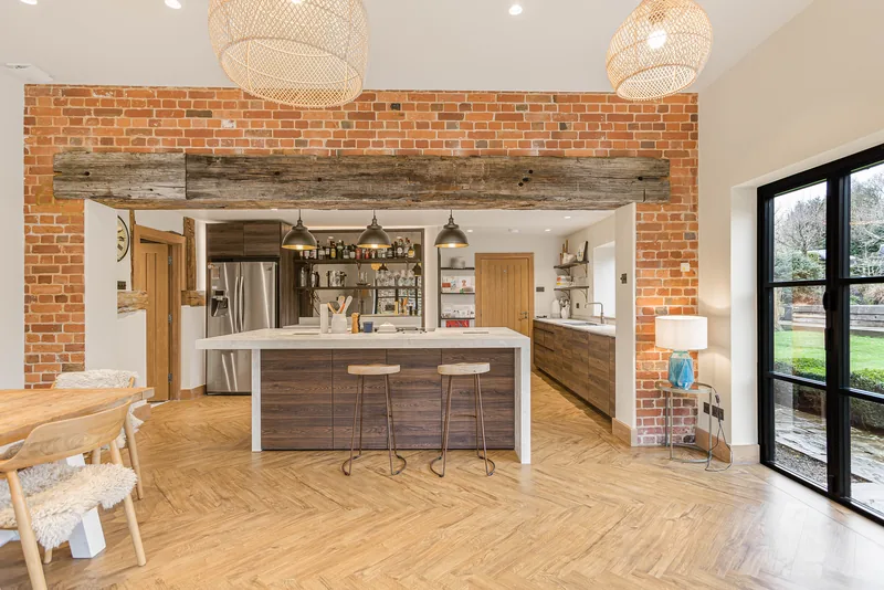 Kitchen seen through the exposed brick opening of the Barn Conversion
