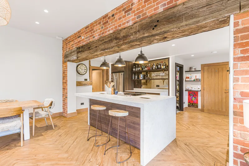 Island, bar and brickwork in the Barn Conversion kitchen